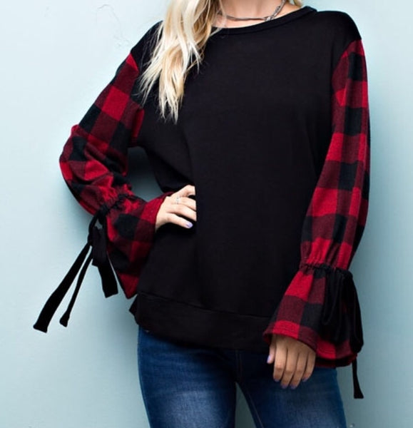 Black knit top with buffalo print sleeve