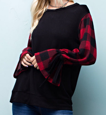 Black knit top with buffalo print sleeve